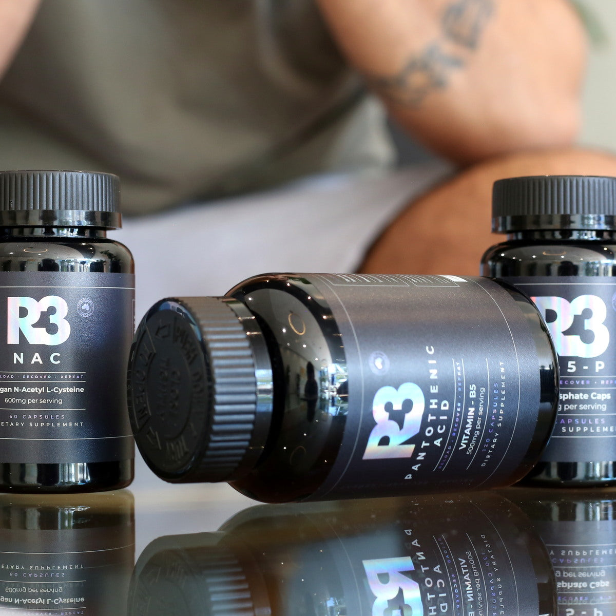 Three R3 supplement bottles on a table